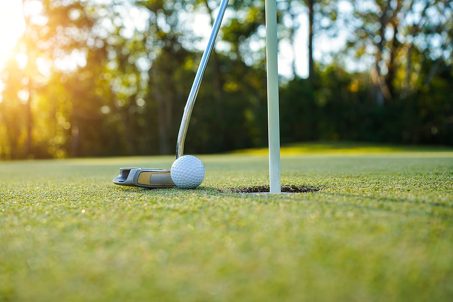 bigstock-Golf-Clubs-And-Ball-On-A-Green-444748970
